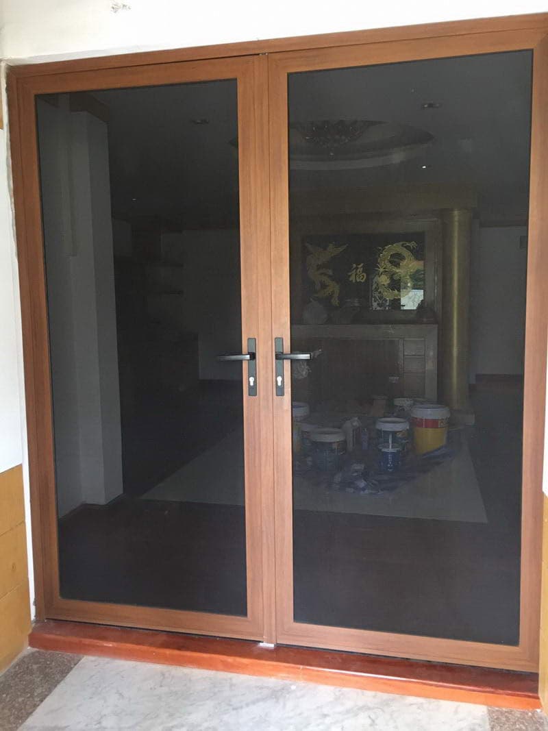Made-to-measure stainless steel security mesh double doors in a timber-coloured frame